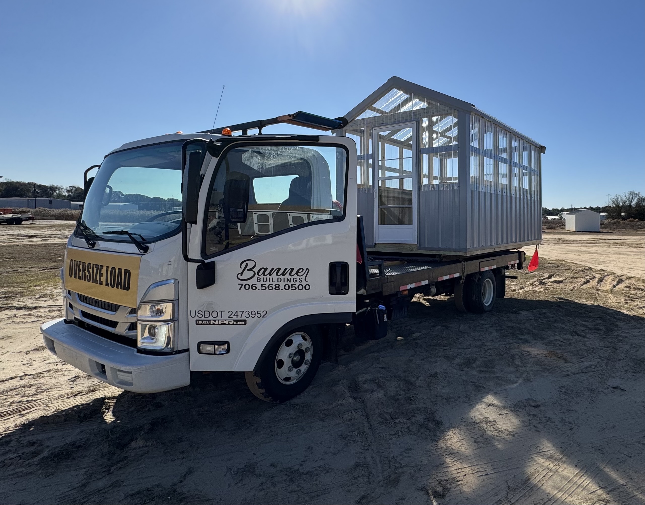 Isuzu truck delivering a storage building