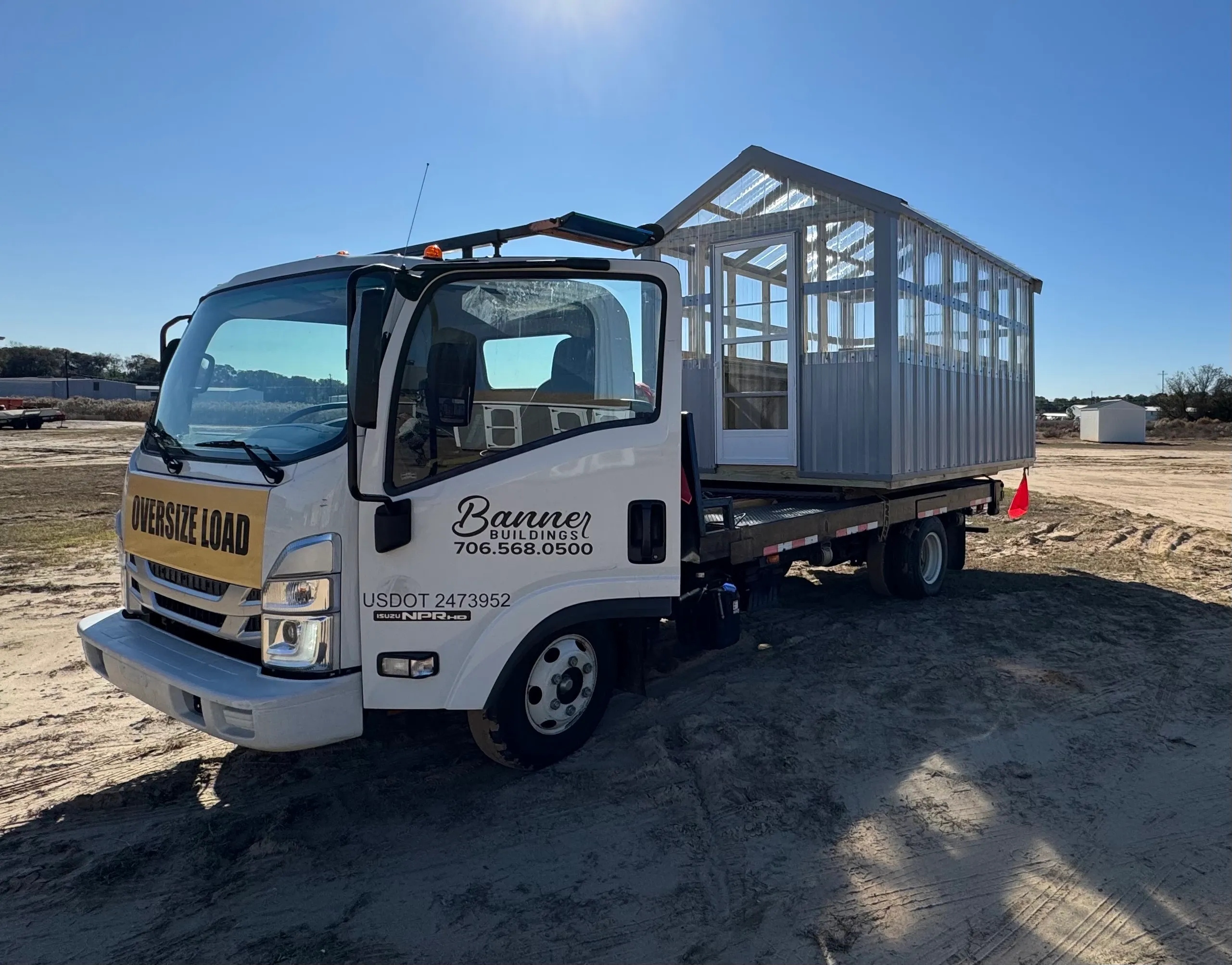 Isuzu truck delivering a storage building