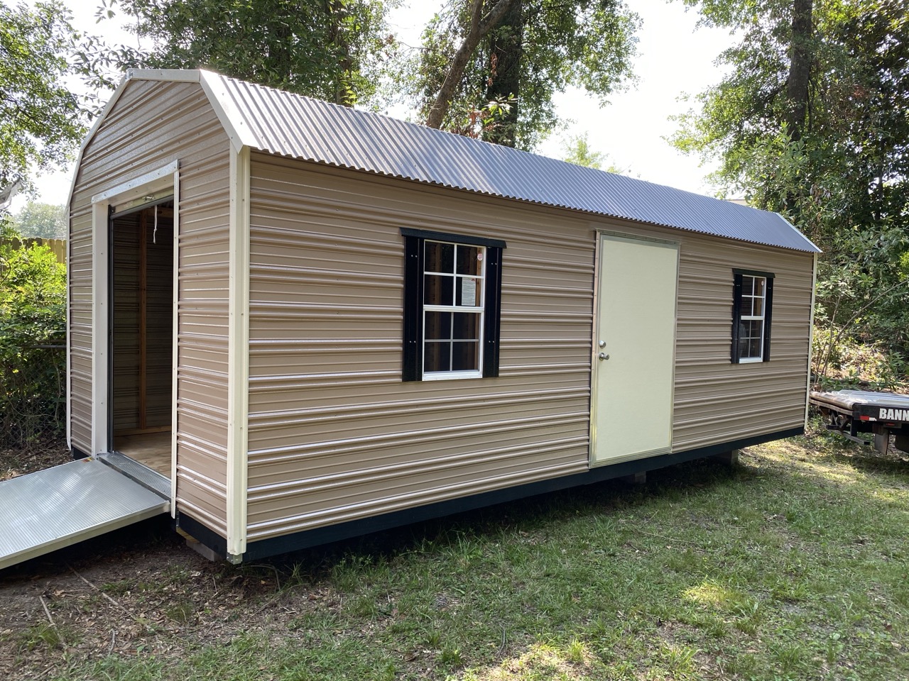 Barn loft style aluminum shed with roll-up door