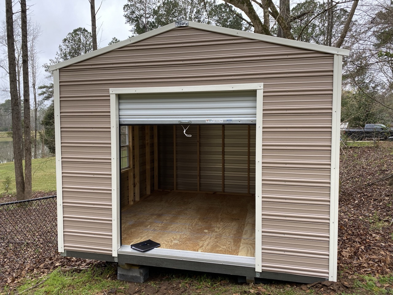 Gray aluminum shed with roll-up door