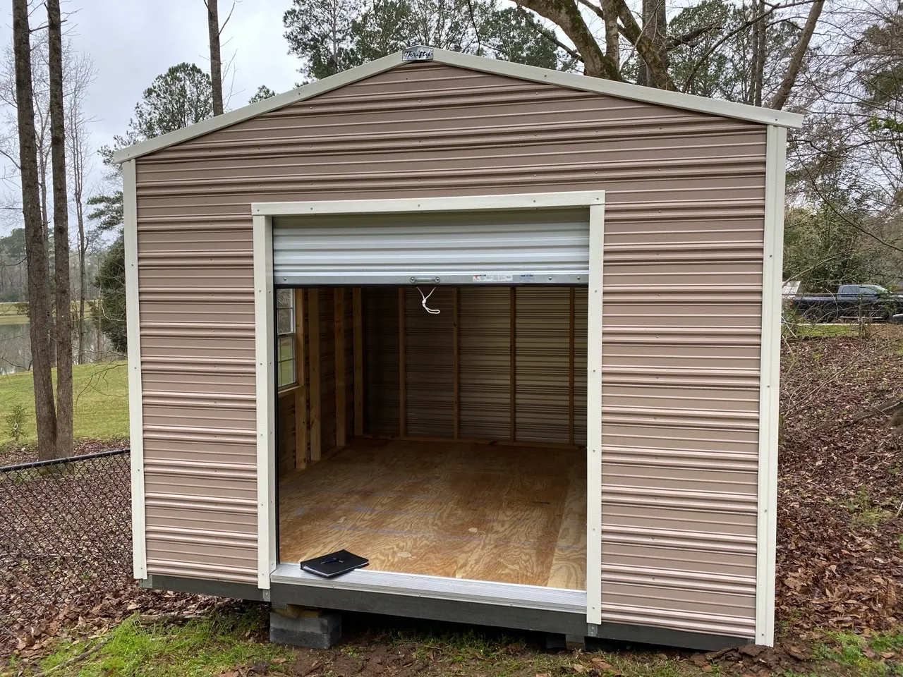 Gray aluminum shed with roll-up door