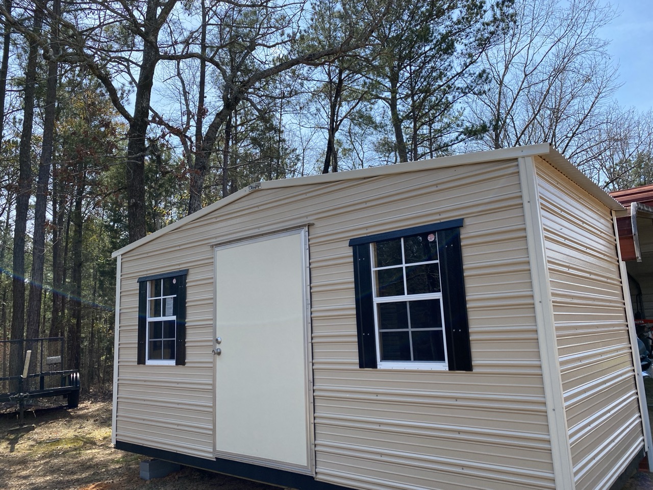 Maroon aluminum shed with ramp and windows
