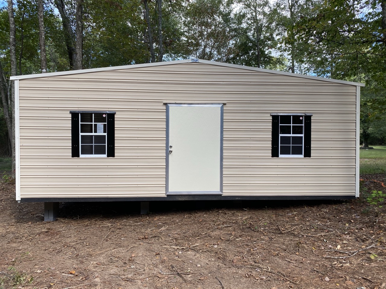 Large aluminum storage shed with black shutters