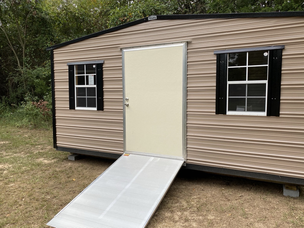 Tan aluminum shed with ramp