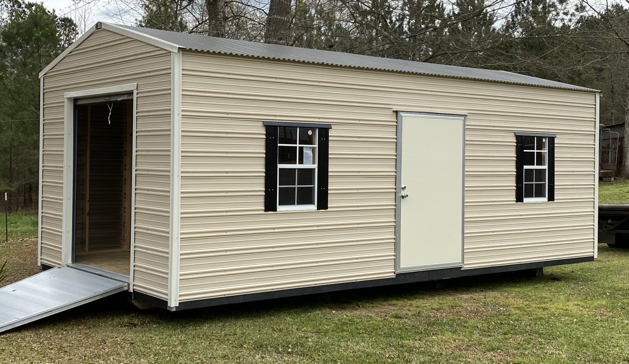 Tan aluminum shed with roll-up door and ramp
