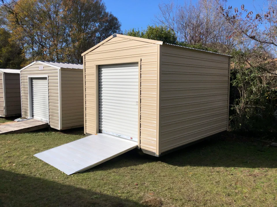10x12 aluminum shed with gable roof, roll-up door, and ramp