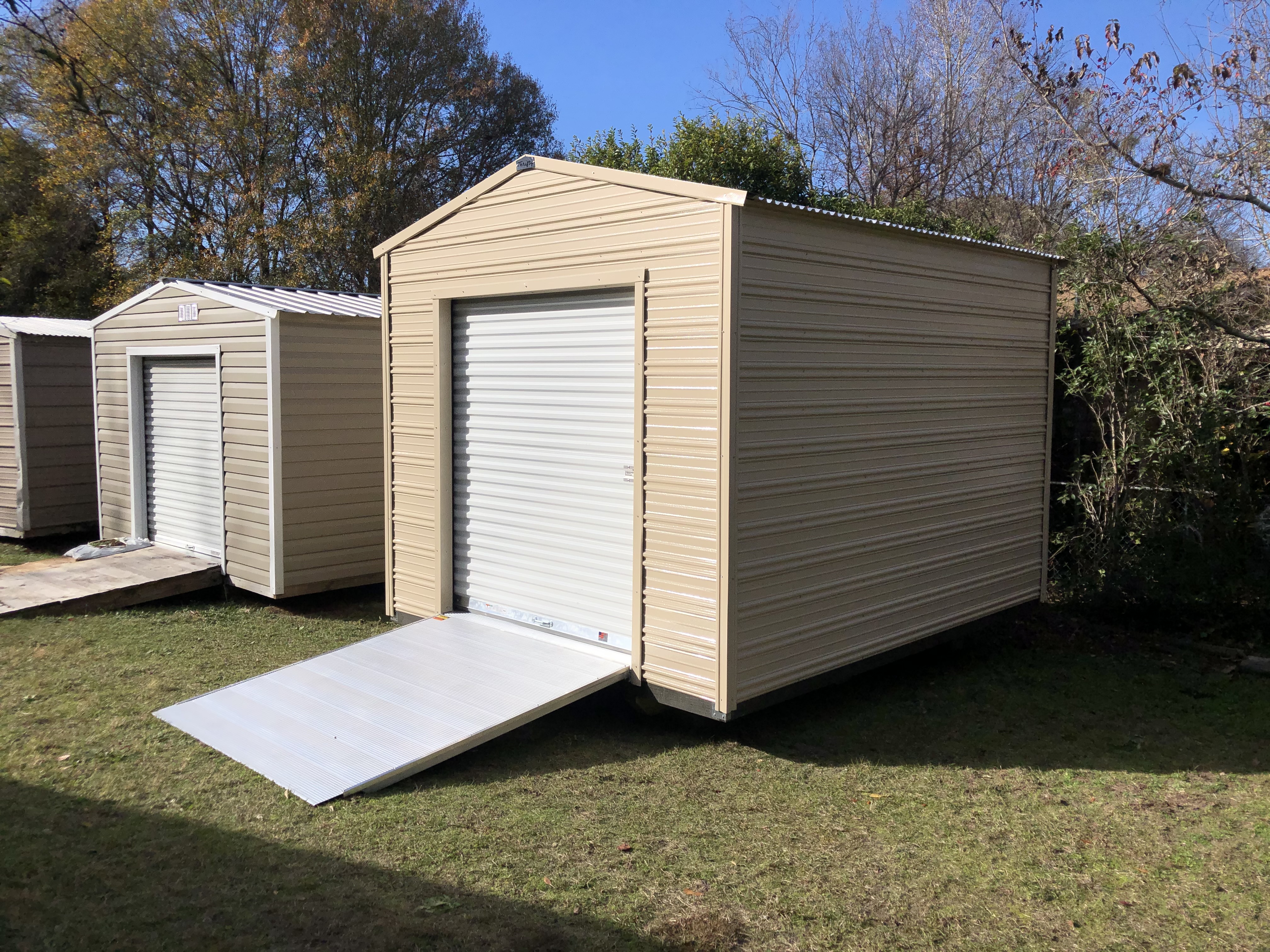 Aluminum shed with garage door and ramp