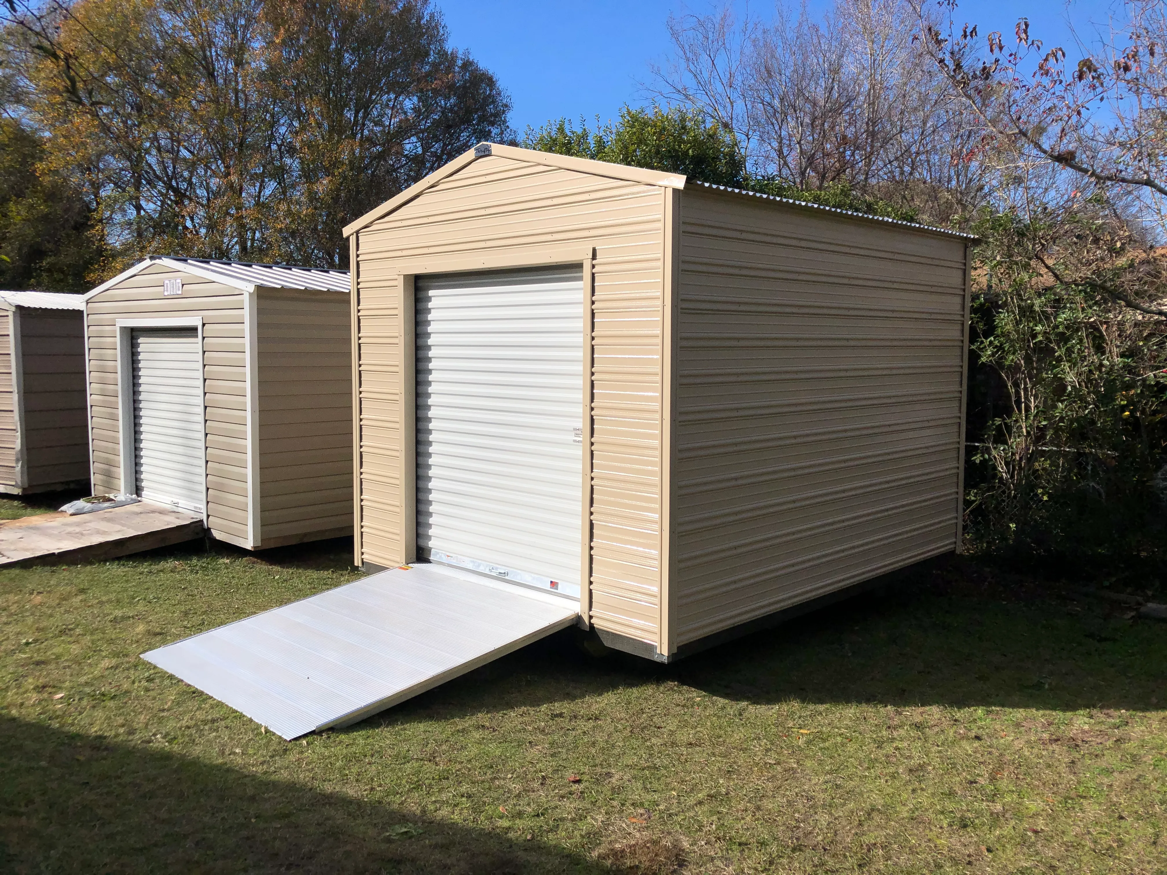 Aluminum shed with garage door and ramp