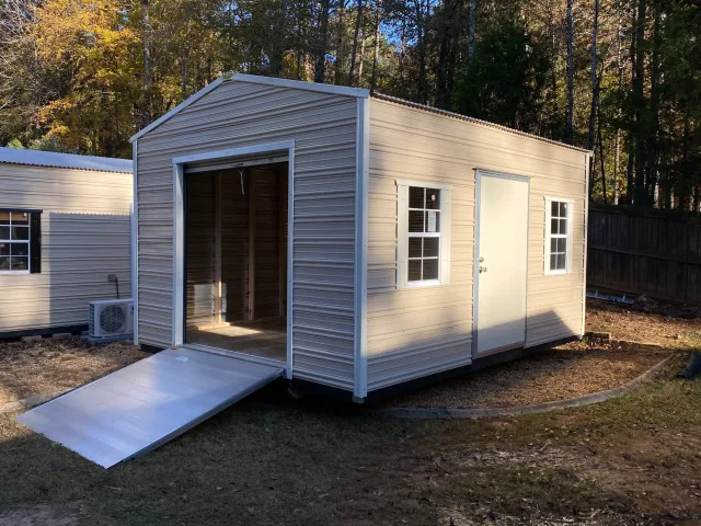Aluminum shed with roll-up door and ramp