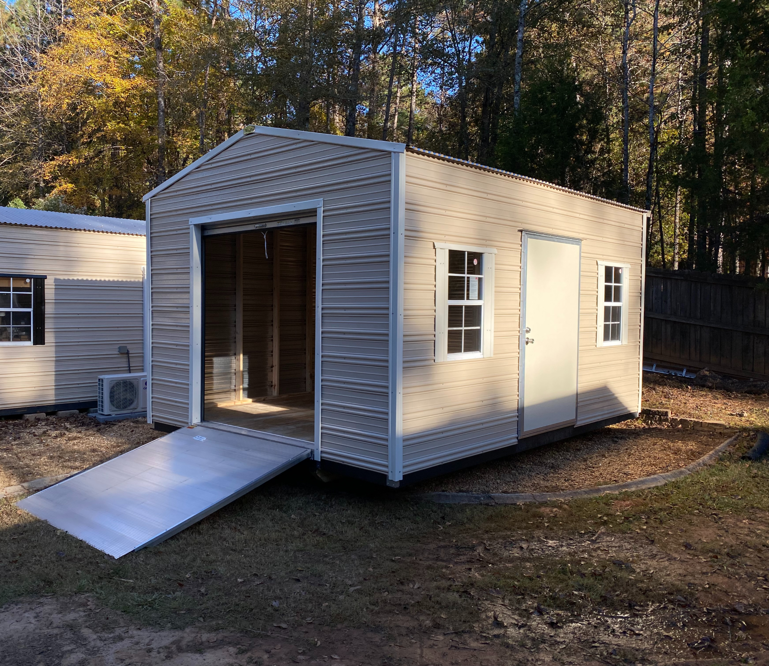 Aluminum shed with roll-up door and ramp