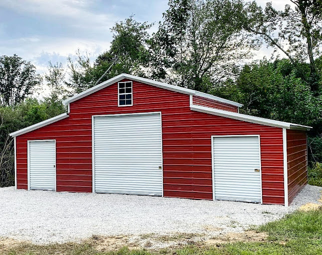 Large red enclosed barn with roll-up doors