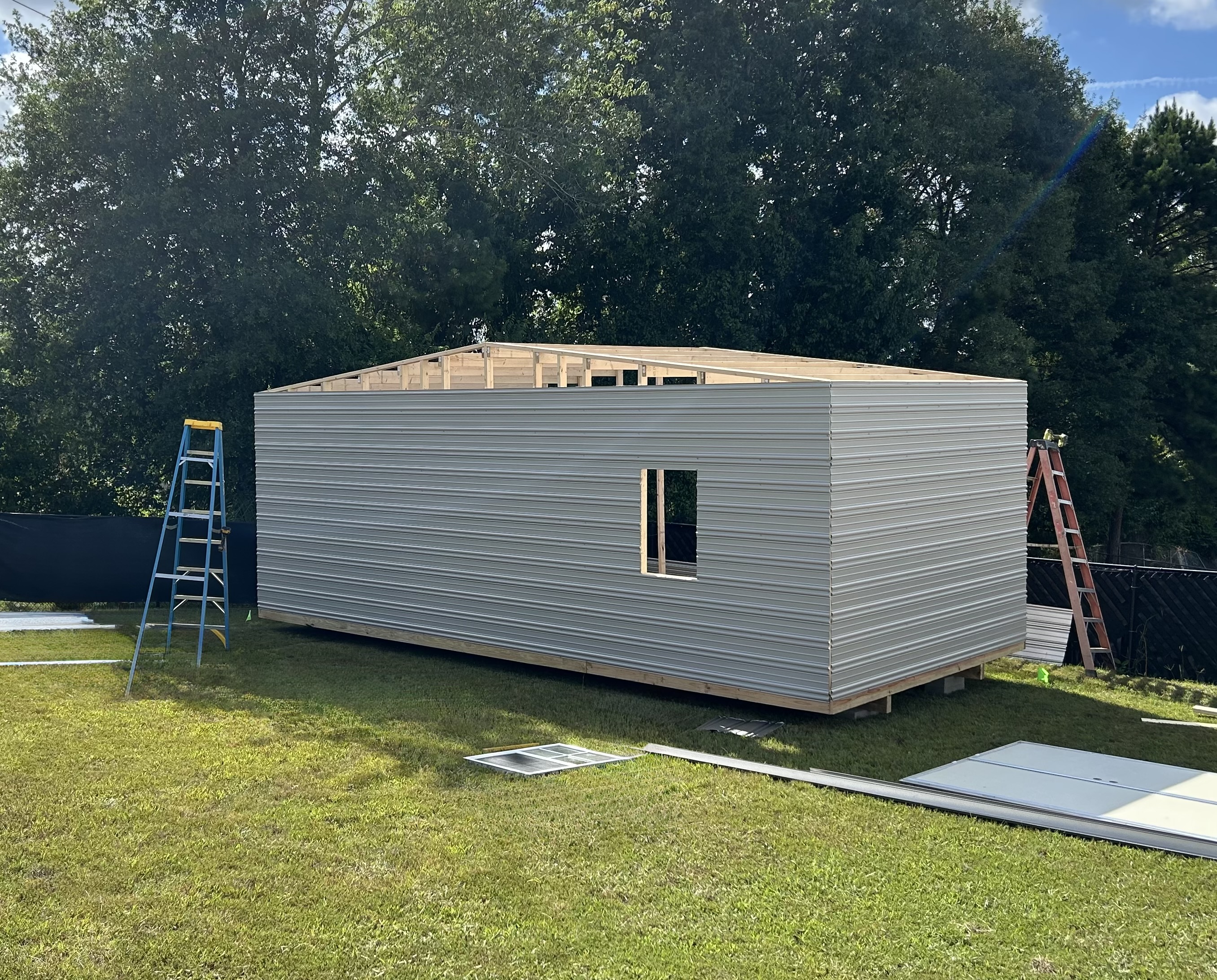Aluminum siding being applied during on-site build