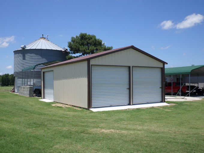 Large garage with vertical siding and two roll-up doors