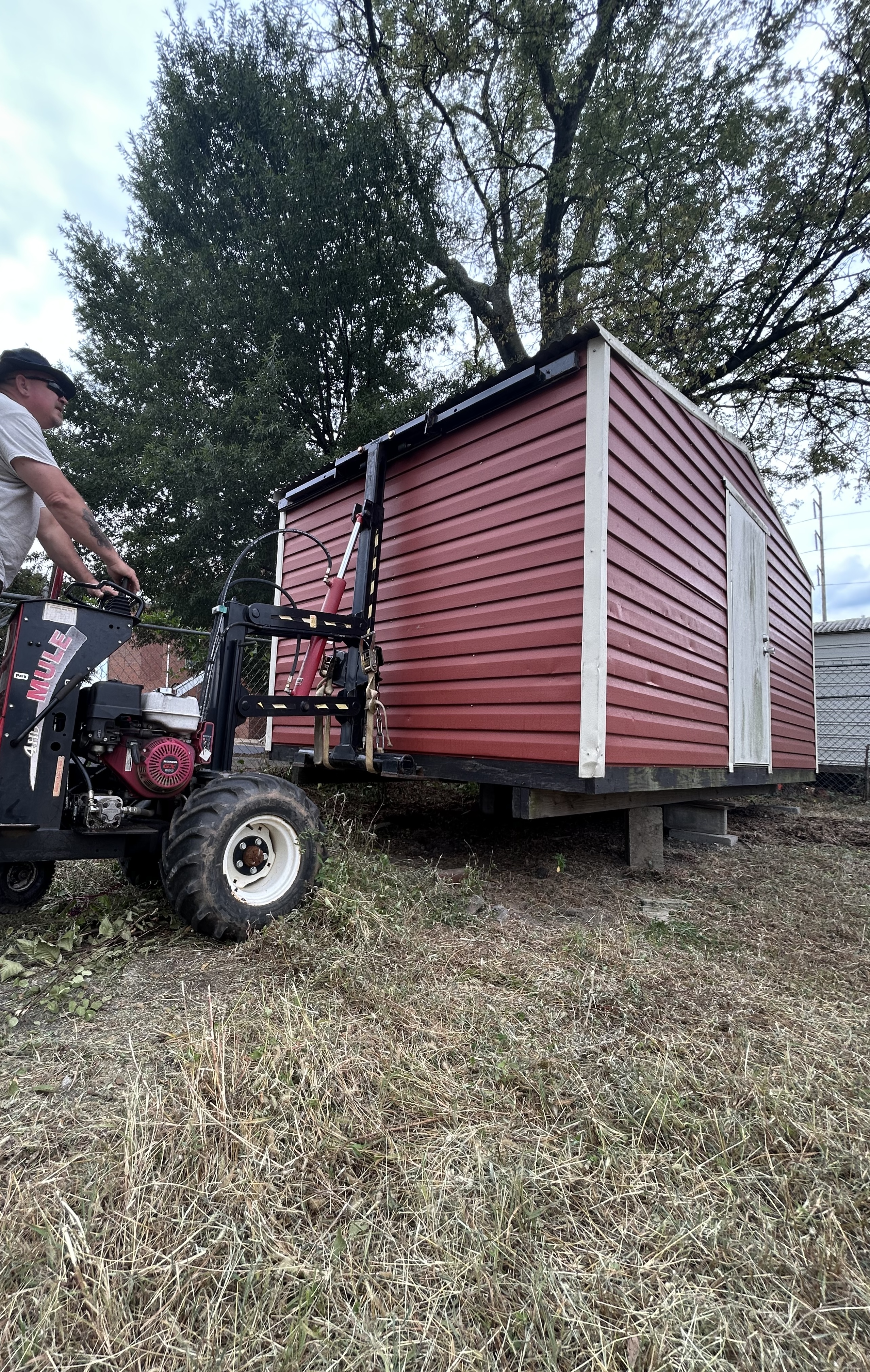 Mule equipment moving a shed