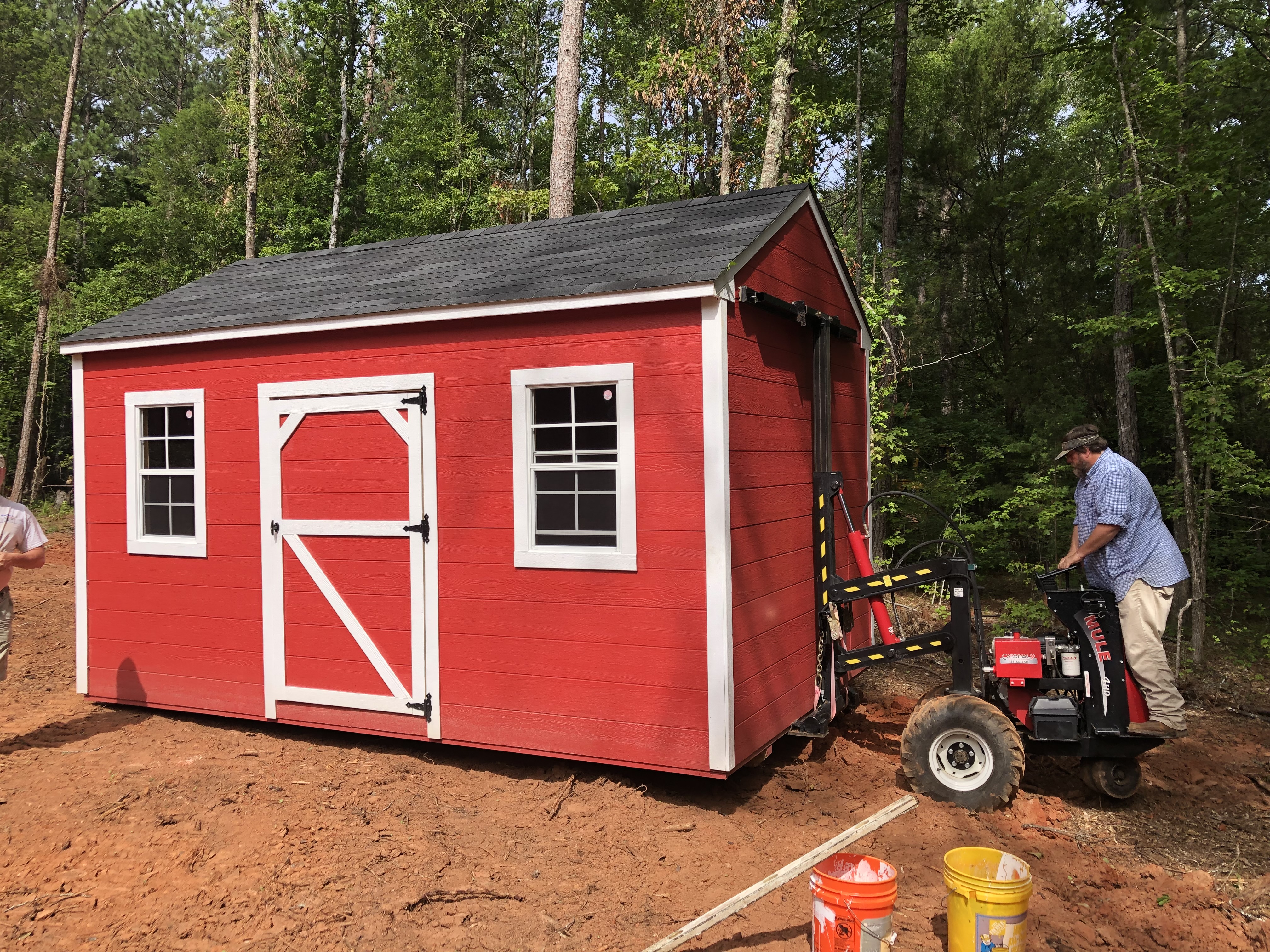 Shed being moved with mule equipment